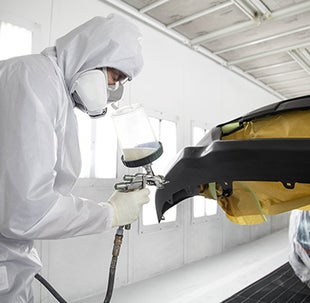 Collision Center Technician Painting a Vehicle | Sloane Toyota of Glenside in Glenside PA