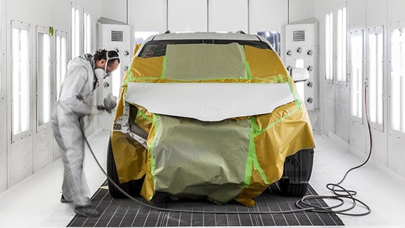 Collision Center Technician Painting a Vehicle | Sloane Toyota of Glenside in Glenside PA
